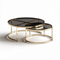 Modern round coffee table set with black glass tops and gold metal frames